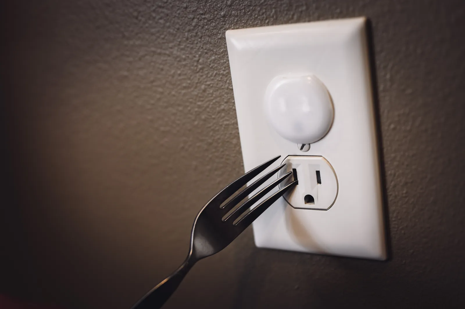 Childproof outlet cover installed for electrical safety in home