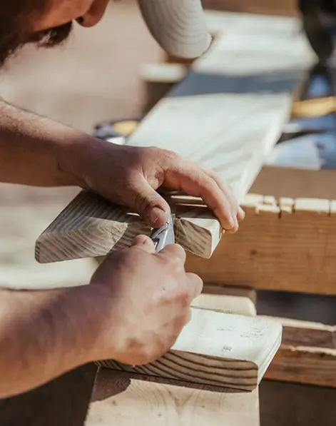 Professional general contractor measuring wood for a home renovation project in Denver, Colorado.